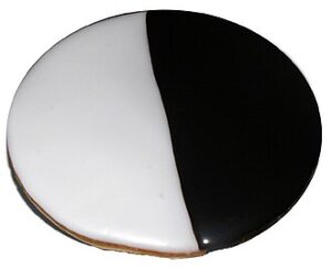 A picture of a black-and-white cookie.