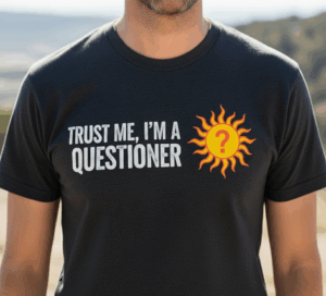 A man wearing a t-shirt that says "Trust me, I'm a Questioner" with the Questioners' logo next to it.