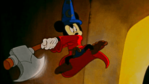 A frame from the Sorcerer's Apprentice segment of Disney's Fantasia, showing Mickey, dressed in his magician clothes and wielding an axe.